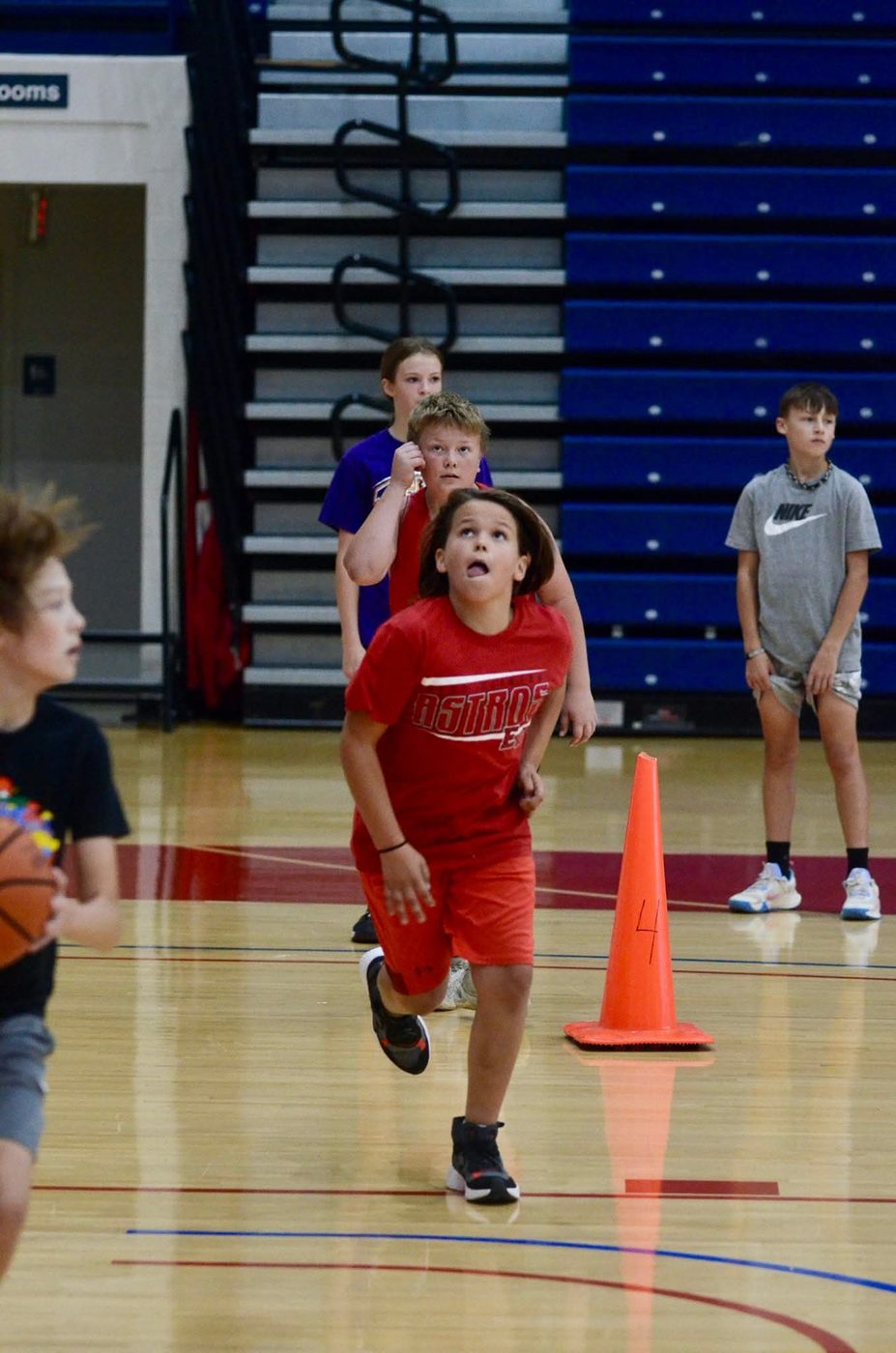 A young athlete running a cone drill during TC3 training